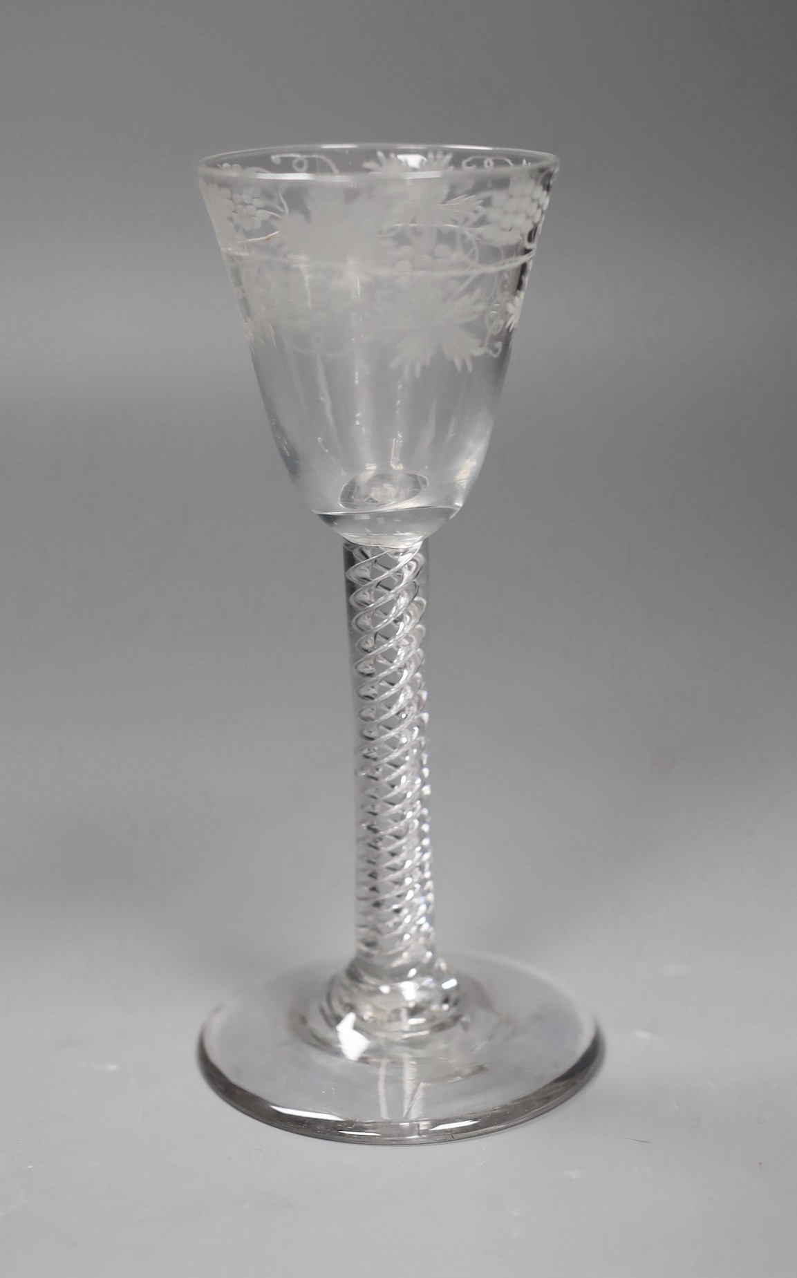 An 18th century engraved air twist stem wine glass, 15cm tall